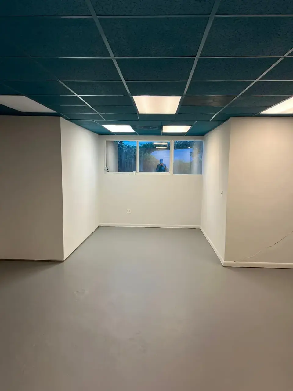 Now: Commercial interior after ceiling tiles and gray floor installation in Miami