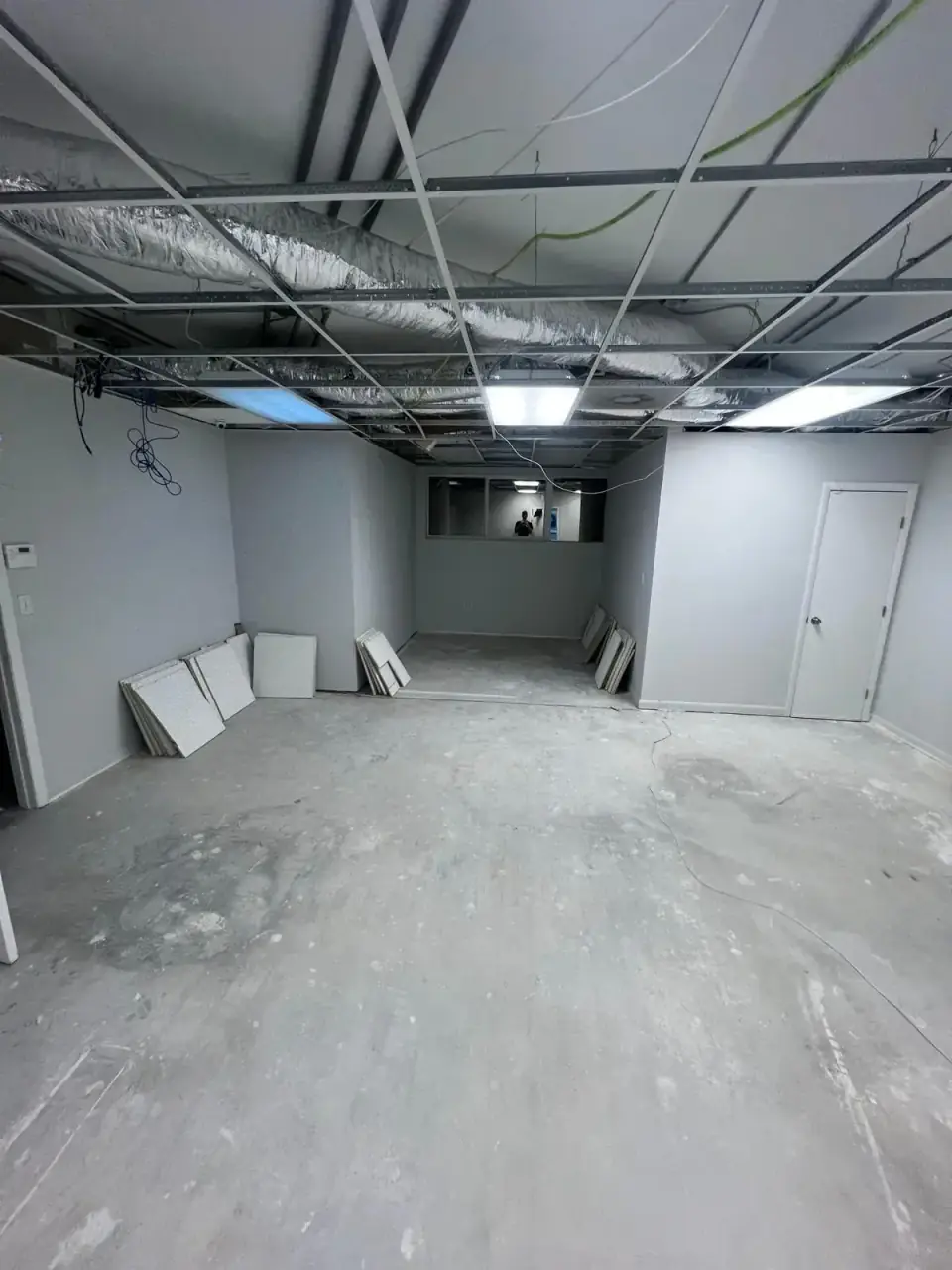 Before: Commercial space ceiling floor and wall unfinished with exposed ducts in Miami