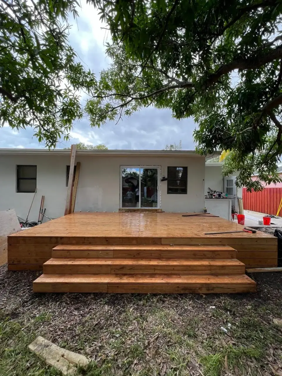 Now: Completed wooden deck installation with steps in backyard area - Miami home improvement