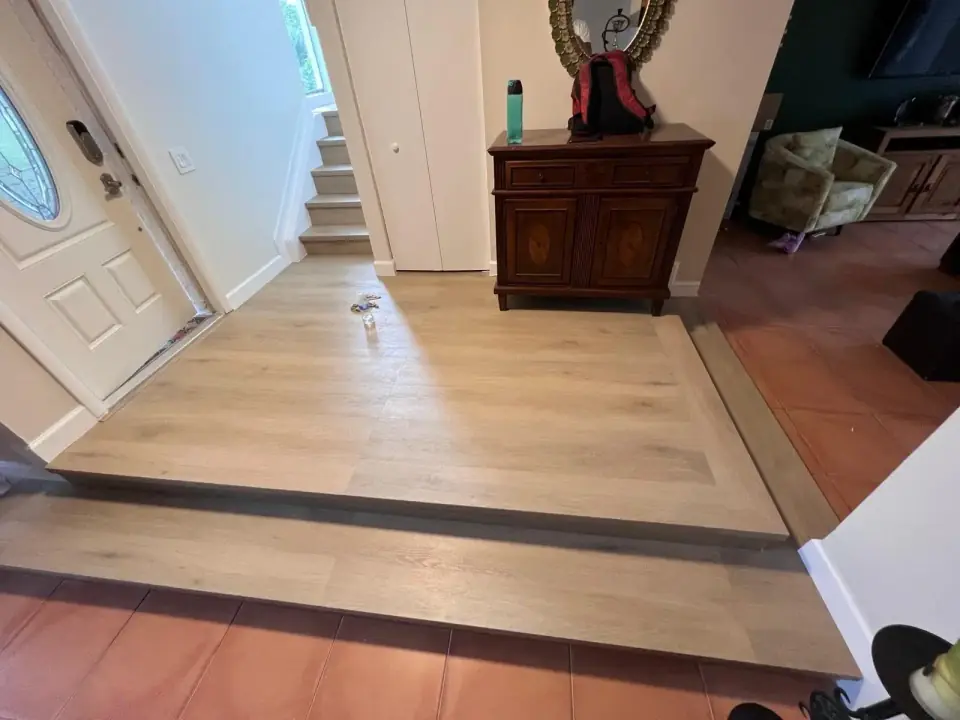 Now: Raised entry platform with new vinyl plank flooring installed in Miami residential renovation