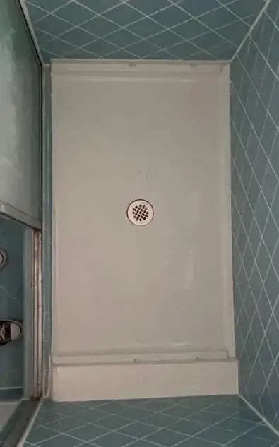Now: Finished shower floor repair with smooth white waterproof coating in Miami