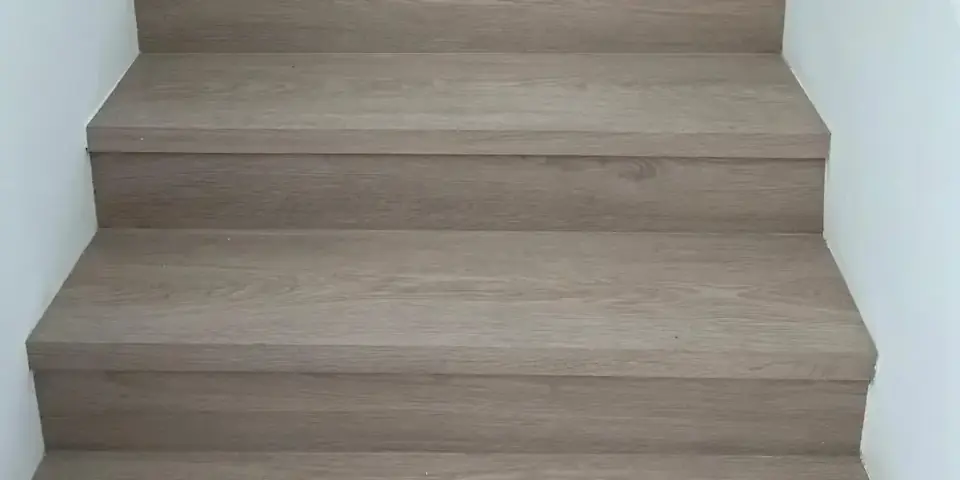 Completed staircase with modern wood-look finish, Miami stairs renovation after installation